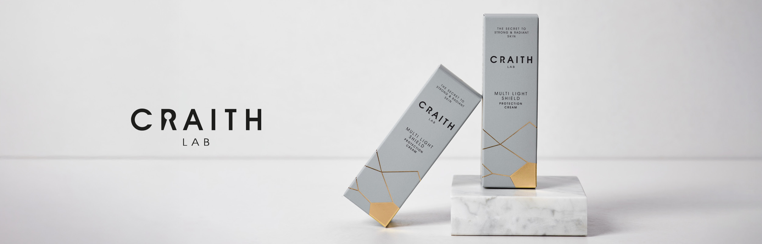Craith Lab Multi Light Shield Protection Cream in grauen Verpackungen auf Marmor